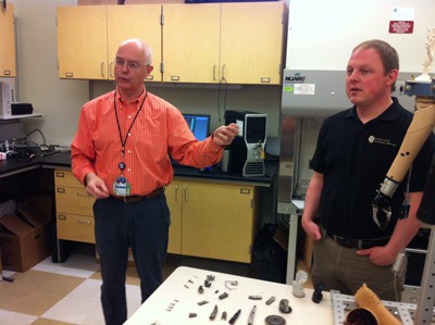 Dr. Richard Weir and research assistant Stephen Huddle explain their bioengineering design and research to make robotic hands. 