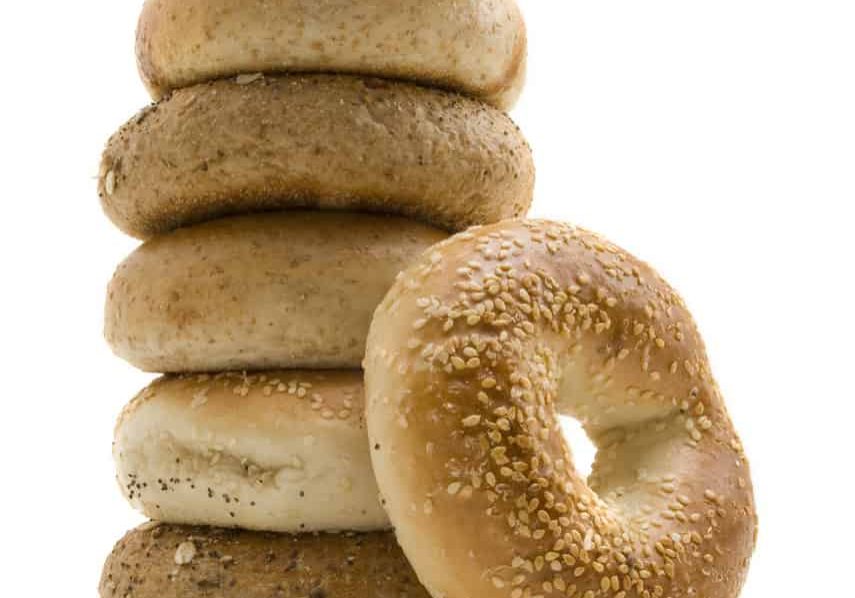 Six healthly lifestyle bagels in a stack.